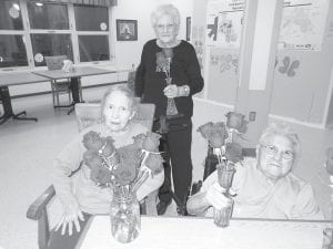 Safe and warm inside, Care Center residents have been enjoying a variety of activities. Trudy Boyd, Skip Rouser, and Bernice LeGarde enjoyed arranging some beautiful roses donated to the Care Center from Terra Bella Floral