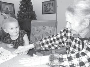 Above: Trudy Boyd gives some encouragement to Genesis Henneman during our intergenerational group- Kids Korner. Left: Don Sorlie Sr. visits with Marco Good. Marco visited the Care Center on January 23 as “Tom MaGee the Lumberjack” sharing lumberjack tales and songs.