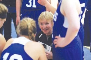 Inset: Head coach Kelly Senty gives her team some no-nonsense instructions during a timeout. Right: Emily Jacobsen (No. 42), trailed by Sarah Toftey, goes in strong for a lay-up in a recent home game.