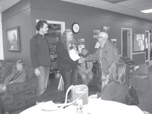 Walt Mianowski, a board member of the Cook County Council on Aging, presents a check to George Wilkes and Stacy Drouillard of the Cook County Local Energy Project—one of the many nonprofits in Cook County that received a payout from the 1st & 2nd Thrift Store.