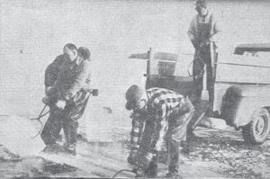 The ice in the Grand Marais harbor was about 18 inches thick in February 1966, when a group of locals went out to cut some ice. Shown using ice tongs, from left, are Tom Eckel Jr., Tom Eckel Sr., and Dick Eckel on the truck. Alfred Fenstad is partly showing in the background. The ice cutting operation came to an end in mid-March, with the arrival of warmer temperatures.