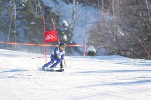 Lutsen Mountains was the scene of the exciting action at the Junior Alpine Ski Meet on January 31. Above: Cy Oberholtzer was the picture of determination on his runs. He was the top Lutsen finisher in the 10-11 age group, in 2nd place. Right: Ray Dressely speeds down Koo-Koo to finish 1st in the 8-9 year old division.