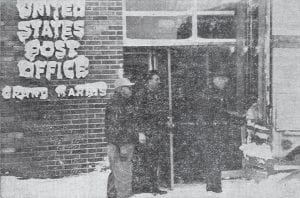 The “Jack Frosted” letters on the Grand Marais post office sign indicate that Cook County had a taste of the great blizzard that whipped the area in early March 1966. Postmaster M.D. Quaife is shown unloading a mail sack from the truck at the front entrance because the back entrance was blocked with snow drifts. Looking on are Joe Thomsen, east route carrier; and Hilmer Isaacson and Jim Dalbec (hardly visible in doorway), clerks.