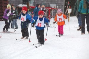 Left: And they’re off! Lief Lindstrom (No. 35) wasn’t too tongue-tied to take a nice lead at the start of the kids’ race. Not far behind was Alex Teeter (No. 82) the grandson of Chris Hegg of Grand Marais. Behind them is a young Canadian skier, who, like the rest of the kids, was learning the art of cross country skiing.