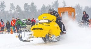 Hundreds of snowmobilers braved a mix of rain and snow to attend the Cook County Ridge Riders Snowmobile Drag Races on Hungry Jack Lake on Saturday, February 20. Jaret Baker shoots a plume of snow as he takes off from the line. See more on page B4.