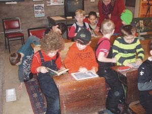 Sawtooth Mountain Elementary students get some “hands on” experience in the old school room at Cross River Heritage Center. The chalk board slates, desks and old school books capture the students’ imagination.