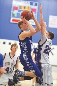 Top: Despite the attempted block, Rory Bakke scored two points on this shot against Hill City. Left: Somehow Jerod Spry (24) didn’t get a foul call as he attempted to go by the defense for a lay-up. Above: Lucas Philips (21), ignored the defense and took the ball straight up and shot over the top of the defender to score 2 of his 8 points against Hill City.