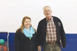 Above: Changing of the guard. Newly elected Supervisor Sarah Somnis and outgoing Supervisor Jim King graciously wished each other well after the election. Right: Augie Schauland casts his ballot in the Tofte township election.