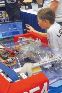 John Vander Heiden worked on the Ice Storm robot during a break from competition on Saturday, March 5. The team from CCHS took 6th place out of 60 teams at the regional robotics meet.