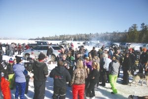 Although the fish didn’t exactly tear the hooks off of their lines, those in attendance for the Cook County Ridge Riders Snowmobile Club annual Trout Derby on Gunflint Lake on Sunday, March 6 had a great time, basking in the warmth and sunshine. Upper left: There was a great turnout on the ice on Gunflint Lake with more socializing than fishing. Lower left: A tasty lunch was offered by the Ridge Riders, with a choice of burgers, brats or fishburgers. Above: And the winners were: (L-R) Lynn Christenson in 1st, Britt Trovall in 2nd, Arlo Christenson (Lynn’s son) in 3rd, Luke Baumann in 4th, Bob Baker in 5th, and Thomas Anderson placed 6th.