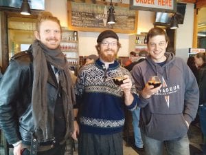 In addition to official mayoral duties such as presiding over Grand Marais city council meetings and participating in the statewide transportation caucus, Mayor Jay Arrowsmith DeCoux gets to perform a number of ceremonial duties, such as offering a toast at an anniversary celebration. Arrowsmith DeCoux was on hand in February when Voyageur Brewing Company hosted a celebration in honor of the completion of its first year in business in downtown Grand Marais. He is pictured here with Jeff Niesen, who created the artwork on the commemorate craft beer bottles and Voyageur Head Brewer Jason Baumgarth. (L-R) Niesen, Mayor Arrowsmith DeCoux, Baumgarth.