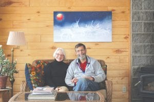 After a year of renovations and refurbishing, Bob Nesheim and Marlys Johnson take a moment to enjoy the redecorated commons room. The room is a place where guests can go to enjoy breakfast, a view of Lake Superior, or the company of other visitors.