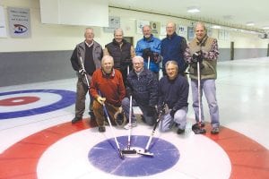 Some of the Wednesday curling crew. (L-R, kneeling) Tom Wentworth, Buzz Flolid, Greg Miron. (L-R, back) Jim King, Chaz Misenheimer, Jim McDermott, Bill Parish, Tom Fredeen. Lower left: Skip Jim King calls out to his teammates as they sweep the stone across the rink. Lower right: Tom Fredeen throws the curling stone with the special handle available for less limber curlers. These senior curlers—the two youngest members of the group are 68 years old and the oldest is 81— meet for a “pick-up” game of curling each Wednesday. Anyone interested in playing is welcome to join them.