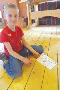 The third graders from Sawtooth Mountain Elementary were the last group to attend the class at North House. Above: After finishing his canoe, this third grader worked on the design phase. Right: These third graders, with help from instructor Brendan Grant, used the watering cans to simulate rain.