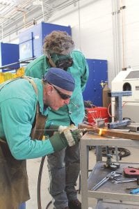 Far left: Instructor Don Hammer shares some tips with Jon Woerheide. Top: Novice welder Mary Sanders enjoyed trying something new. Left: All students take home an obelisk, created by using several different welding techniques.