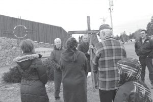 Community members gathered for a Good Friday Cross Procession on Friday, March 25, stopping to offer prayers for each of the congregations in the county. Left: Father Seamus Walsh offered a prayer at Highway 61 for churches on the east and west ends of the county. Above: Pastor Mark Ditmanson gave a prayer for the members of First Congregational Church. The procession ended at Bethlehem Lutheran Church where an ecumenical service was held with Reverend Beth Benson giving the homily.