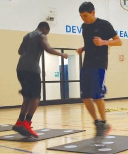 Jerod Spry and a classmate performing the Dot Drill on the new mats donated by the Grand Marais Lions Club.