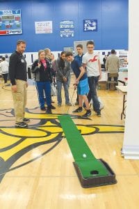 The College & Career Fair at School District 166 on Friday, March 25 gave students the opportunity to learn about the wide variety of jobs available in our region with representatives from law enforcement, healthcare, hospitality and more. There were also representatives from six colleges sharing educational options. Above: Heath Ekstrom, PGA, head golf professional at Superior National at Lutsen talked to students about the different types of jobs available in the golfing industry—and offered some putting tips. Right: Members of the Army National Guard were on hand to talk about the different types of jobs and training available with the military.