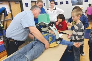 Above: Cook County North Shore Hospital Ambulance Director Steve DuChien and EMT Nicole Bockovich talked about careers in emergency medicine and demonstrated how the LUCAS automated chest compression device works, with help of willing “patients.”