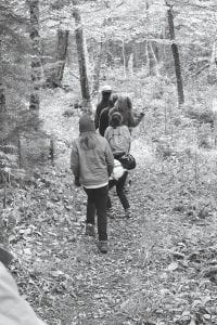 As part of the ongoing studies of interaction between wolves, moose and vegetation on Isle Royale, the National Park Service has created an “exclosure” near Windigo Harbor. The exclosure keeps moose out so researchers can compare this moose-free zone with the rest of the island, which is possibly being over-browsed by the large herbivores in the absence of a healthy wolf population. Left: A park ranger leads a group of Girl Scouts through the exclosure. Inset: The sign designating the exclosure area.