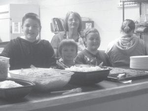 The Grand Portage Elders are not letting the lingering winter weather get them down. Some of the kids helping out at the “Spring Fling” were Dante Deschampe, Nickolas Spry, Cook Judy Ranta, Wei-Lani Likiaksa and Raina Christianson.