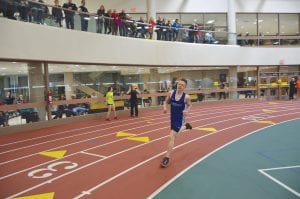 The Vikings had a great start to the track season at the indoor meet at UWS. Top: Henry DeArruda-Weaver sprints hard in the 400-meter run. Far left: Maya McHugh grins as she takes 1st in the 800-meter run. Left: Alicia Smith cushions the shot put under her chin, as she gets ready to throw. Above: Zoe Nonnemacher shows some good speed in the 55-meter dash.