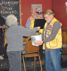 On April 8, the Grand Marais Lions Club selected the lucky winners in their Vision Screening raffle. Proceeds have been given to purchase a Spot Vision Screener. The equipment can be used to screen everyone from tiny tots to senior citizen. The equipment can efficiently and quickly screen and print out results. Lion Al Taenzer looks on as Elsie Smith picks the lucky winners and Lion President Bob Spry makes the announcement. Three gas cards with a value of $400 each were the raffle prizes. The winners were Bob Smith, Janet Breithaupt and Valerie Gustafson, all residents of Cook County.