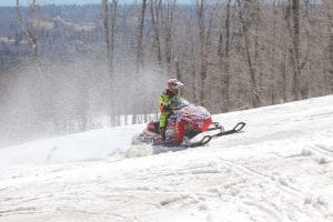 Snow wasn’t falling, but it was flying on Moose Mountain during the MidWest Extreme Snowmobile Challenge on Friday – Sunday, April 15-17. Bobby Menne of Virginia, Minnesota roars up the mountainside.