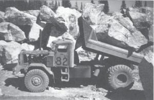 Carlton Peak in Tofte provided the armor stone for the break wall at Taconite Harbor. The 2- to 15-ton stones cut from its face were so large that a trailer truck could carry only two at a time. They were placed on the rock core by derrick boat.