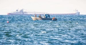 Thomas J. Spence of Tofte was in just the right place with camera in hand to capture this moment on Lake Superior. Spence appropriately named the photo Working Superior. It features Harley Toftey and the Dockside Fish Market crew tending nets as the Cason J. Callaway passes the Grand Marais harbor on Tuesday, April 26.