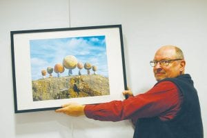 Last week Peter Juhl was busy hanging photographs of his unique “rock balancing” art in the Cook County courthouse. The unique pictures are on the main floor and demonstrate both his photographic skills and his ability to find the center of gravity and balance points to objects where most wouldn’t think one exists.