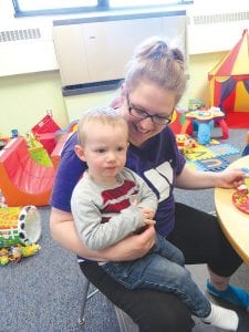 It wasn’t the peas and carrots that scared this little fellow, it was the scary reporter who was trying to get him to smile for a picture. A quick cuddle from the Y staffer corrected the problem.