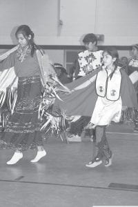 Two young girls in shawl dresses danced to the drums and songs that filled the gymnasium at the Grand Portage Community Center during the Honor our Elders Powwow held on Saturday, May 7.