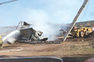 As the Maple Hill and Grand Marais fire departments got the fire at Hedstrom Lumber under control on May 8, lumber mill equipment operator Mike Kimball assisted by knocking down the crumbling metal walls.