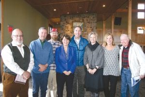 Above: U.S. Senator Amy Klobuchar made a quick visit to Lutsen on May 5 to meet with area business leaders and governmental officials to discuss areas where she might be able to help the county. Meeting with the senator were (L-R) Jim Boyd, Scott Harrison, Jay Arrowsmith DeCoux, Senator Amy Klobuchar, Tom Rider, Heidi Doo- Kirk, Linda Jurek Kratt, and Hal Greenwood. Left: Tom Rider shows Senator Klobuchar where the hoped-for expansion of the ski hill will occur.