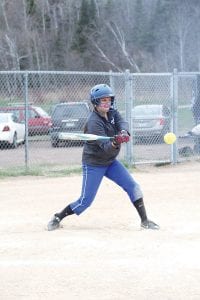 Above: Looking determined, Hanna Borson drove this ball for a single in the game against Moose Lake/Willow River. Right: Behind this cloud of dust is Jamie Johnson sliding hard to avoid the tag from the catcher. When the dust settled the umpire called Johnson safe.