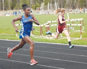 Above: Zoe Nonnemacher ran strong to the finish line in the girls’ 4x200 meter relay at the track meet held in Esko. Far left: Tarin Hanson, below left, ran a fine leg in the girls’ 4x800 meter relay. Left: Jack Haussner, pressing hard, helped the boys to a second place finish in the 4x800 meter relay.