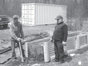 Above: Andy Schmidt and Dennis Westerlind are building a new raised bed at the ENP so more fresh vegetables can be enjoyed at ENP. Left: Ellen Olson and Elder Nutrition Program Head Cook Polly James man the Elders’ raffle table at the May 7 Powwow.