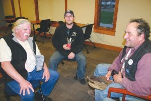 Gary Defoe Jr., in the center holding a cluster bomb, and Frank Koehn (left) talked to Marco Good (right) about the attempts the Red Cliff Band of Lake Superior Chippewa are making to have the government remove the 1,400 to 1,500 steel barrels filled with military waste from the bottom of Lake Superior dumped there in the late 1950s and early 1960s. Koehn and Defoe Jr. brought the discussion to the Grand Marais Library on Wednesday, May 11.