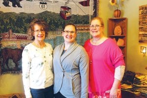 Carrying on the tradition of welcoming all to the store are (L-R) Nancy Cihlar, Emily Cihlar and Cheryl Hovde. They are standing in the room that once held sewing equipment for Heavy Duty Sewing, which is still offered at Great Gifts.