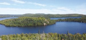 The Caribou Lake Property Owners Association included an interesting look at the history of the people who have called Caribou Lake home from Bob Dunn’s viewpoint. The photo is taken from White Sky Rock looking at Dunn’s cabin site on Caribou Lake.