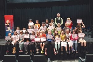 Above: Cook County Sheriff Deputy Ben Hallberg is the D.A.R.E. officer. He was pleased to present certificates to the fifth-graders who had completed the D.A.R.E. course at a program on May 24. Left: Three D.A.R.E. graduates received special recognition. Kylie Viren won a prize for her D.A.R.E. poster in a statewide contest. Migizi Currie and Haley Fontaine wrote winning essays. (L-R) Kylie Viren, Migizi Currie, Haley Fontaine, Deputy Hallberg.