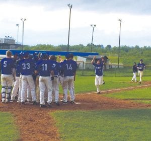 With the team to greet them, Frankie Miller and Leo Johnson trot in with the winning runs against Carlton on a hit by Jack Wieben.