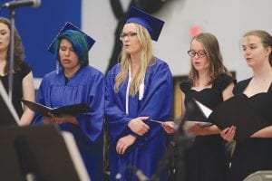 Above: Seniors Isabel Wahlers (left) and Shae Morawitz, in cap and gown, sang with the Cook County High School choir one last time. Left: Receiving special recognition for completing the welding program through Lake Superior College were (L-R) Frankie Miller, Leo Johnson, Jaret Baker. Presenting the certification was Jeremy Leffelman.