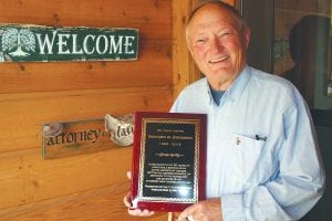 Grand Marais attorney Dick Swanson displays the plaque he was recently given by the 11th District Bar Association for his 50-plus years of excellent legal work he performed while mostly living in Cook County. Besides his legal work, Swanson has been a long-time promoter of the arts and outdoor sports in the county.