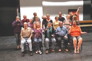 The crazy cast members of the two plays that will be repertory this summer agreed to ham it up a bit. (L-R, seated) Most of the cast of Arsenic and Old Lace: Braidy Powers, Louise Reavis, Beth Benson, Bob Padzieski, Jane Gellner. (L-R, standing) The Addams Family cast: Stage Manager Brenna Hay, Ron McClellan, Jane Healy, John Bragstad (behind), Robin Henrikson, Mark Abrahamson, Karen Blackburn, Karina Roth, Mike Roth, Amelia Roth, Jackson Nickolay, Abby Stoddard.