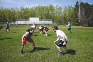 Coach against player: Mark Marxen (left) lined up to defend Bryan Carpenter in a recent alumni practice. Carpenter, an assistant coach for the CCHS Vikings, coached Marxen two years ago. The alumni will meet on the CCHS gridiron on July 2 to raise money for several CCHS sports programs. Tickets to the game can be purchased at Grand Marais Dairy Queen, from individual players or at the gate on game day.