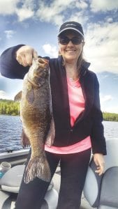 Barbara Whelon of Shoreview, Minnesota caught two nice fish—a small mouth bass and a walleye—on a beaver flick from the Beaver House with a slip bobber in 2 feet of water on Memorial Day. Whelon shows off the bass caught while fishing with Joe Carlson of Joe’s Inland Fishing.