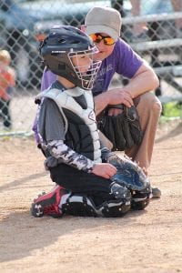 Above: Lion Catcher Oscar Mielke gets some advice from umpire/ parent helper Ben Silence. Above middle: Graham Oberholtzer concentrates on getting a hit for the Lions. Above right: Cade Smith at bat for the Lumberjacks. Right: Lumberjack Jorjah Backstrom racing for home.