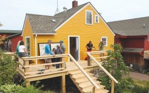 Above: North House Folk School had two ribbon cuttings during the weekend, celebrating its expansion to 501 Highway 61 and celebrating the renovation of the yellow building which will now house the school store and registration office. Right: There are crafts of all kinds during the Wooden Boat Show, including an oar making course.